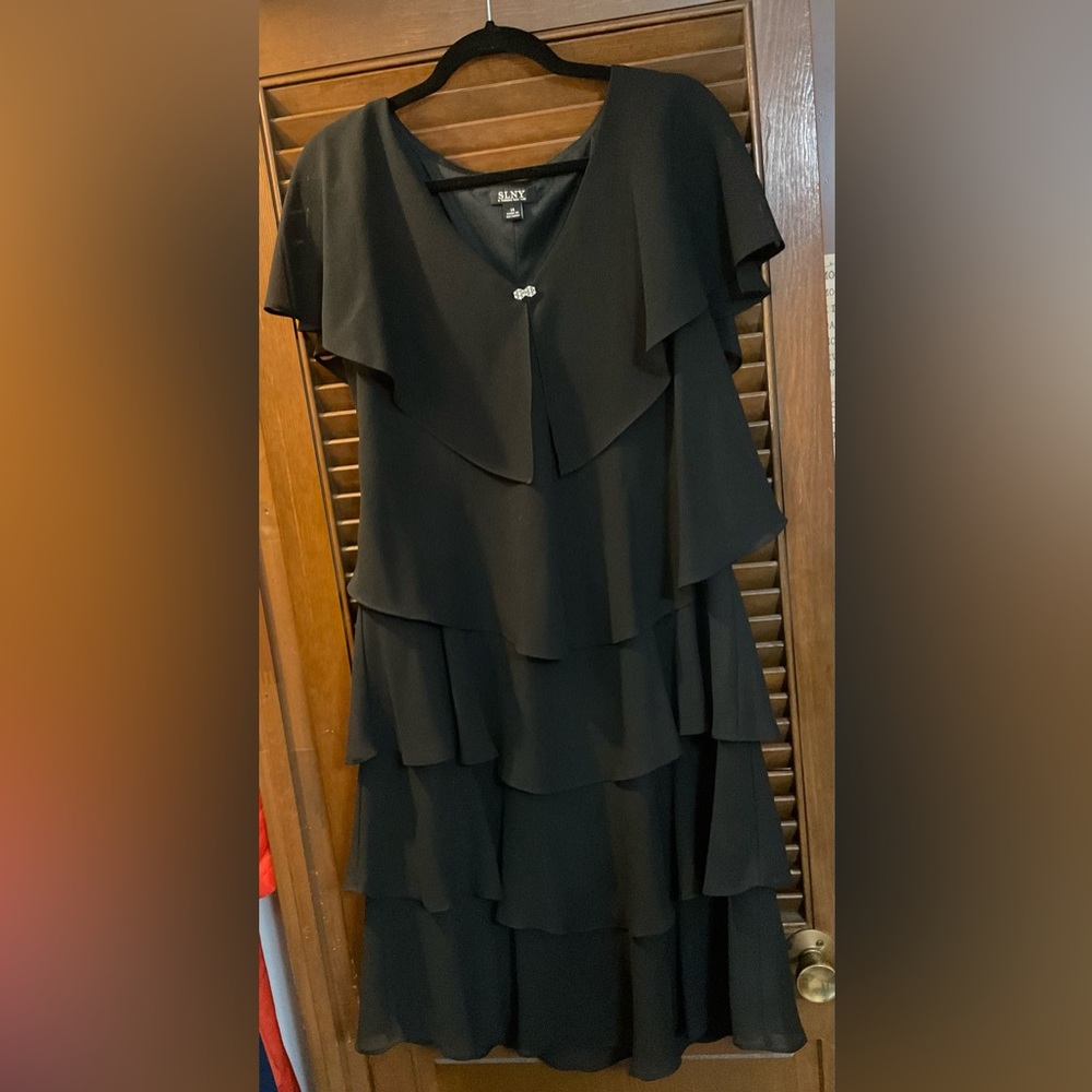 SLNL: black evening dress with big ruffles on front and back.